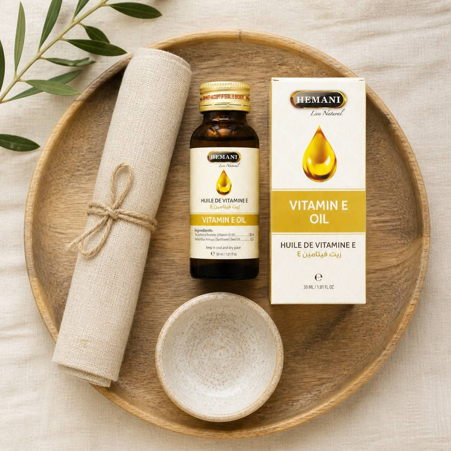 2 Huile de Vitamine E 30mL 100% Naturelle Hemani – rituel d'utilisation vu du dessus, ambiance naturelle zen