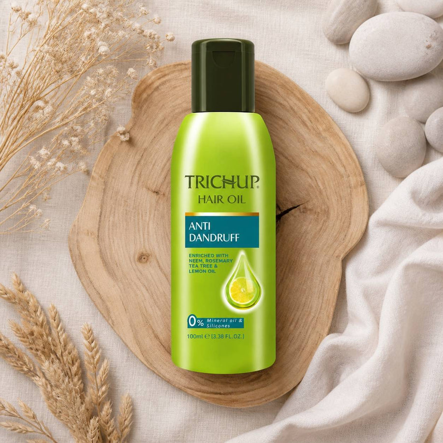 Huile Anti-pelliculaire Trichup 100 mL – composition flat lay avec éléments naturels, vue du dessus
