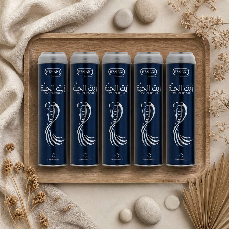 5 Huiles de Serpent Pour la Pousse des Cheveux Zait Al Hayee - Hemani - 250 ml – composition flat lay avec éléments naturels, vue du dessus