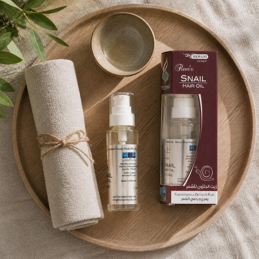 Pack 1 Crème à la bave d'escargot + 1 Huile d'escargot HEMANI 60ml – rituel d'utilisation vu du dessus, ambiance naturelle zen