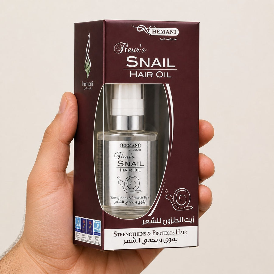 Huile capillaire à la bave d'escargot - Hemani 60mL – taille et contenance réelles du produit en main