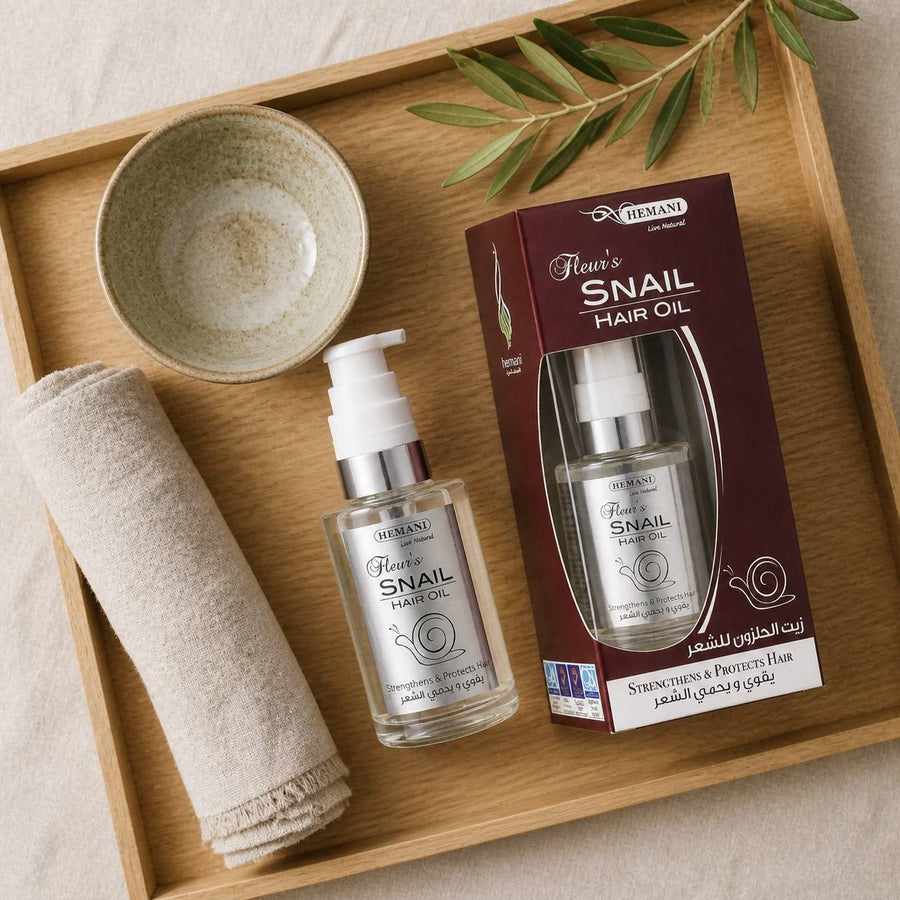 Huile capillaire à la bave d'escargot - Hemani 60mL – rituel d'utilisation vu du dessus, ambiance naturelle zen